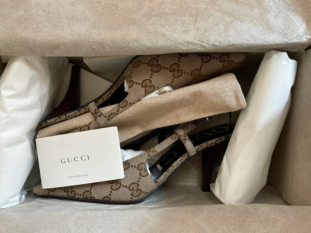 Elegant Gucci heels with iconic logo pattern elegantly boxed for stylish presentation