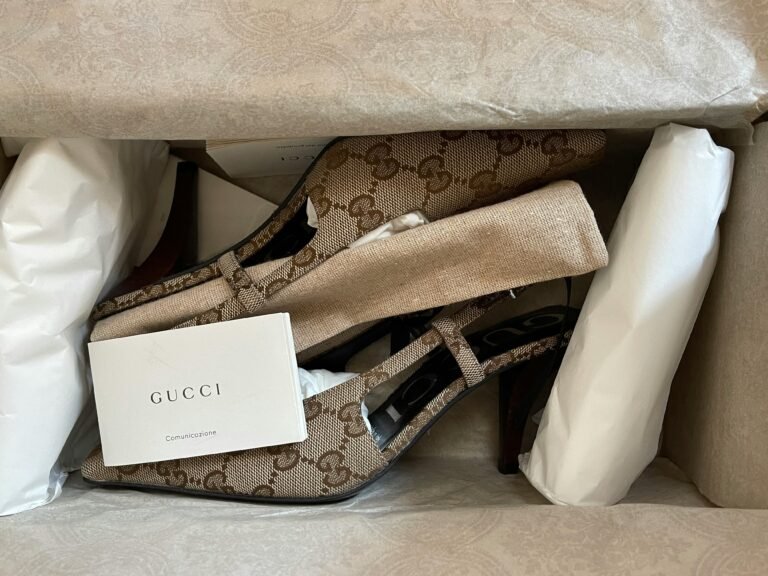 Elegant Gucci heels with iconic logo pattern elegantly boxed for stylish presentation